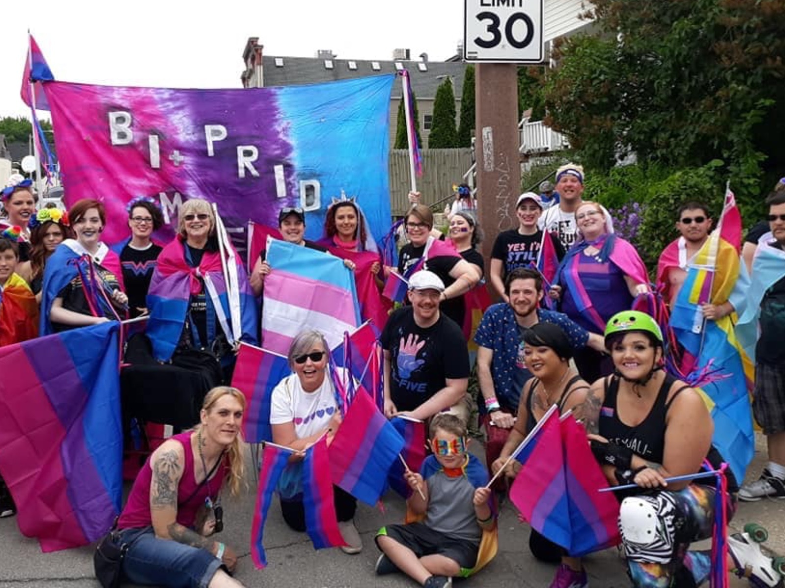 Bi+ Pride Milwaukee members holding bi