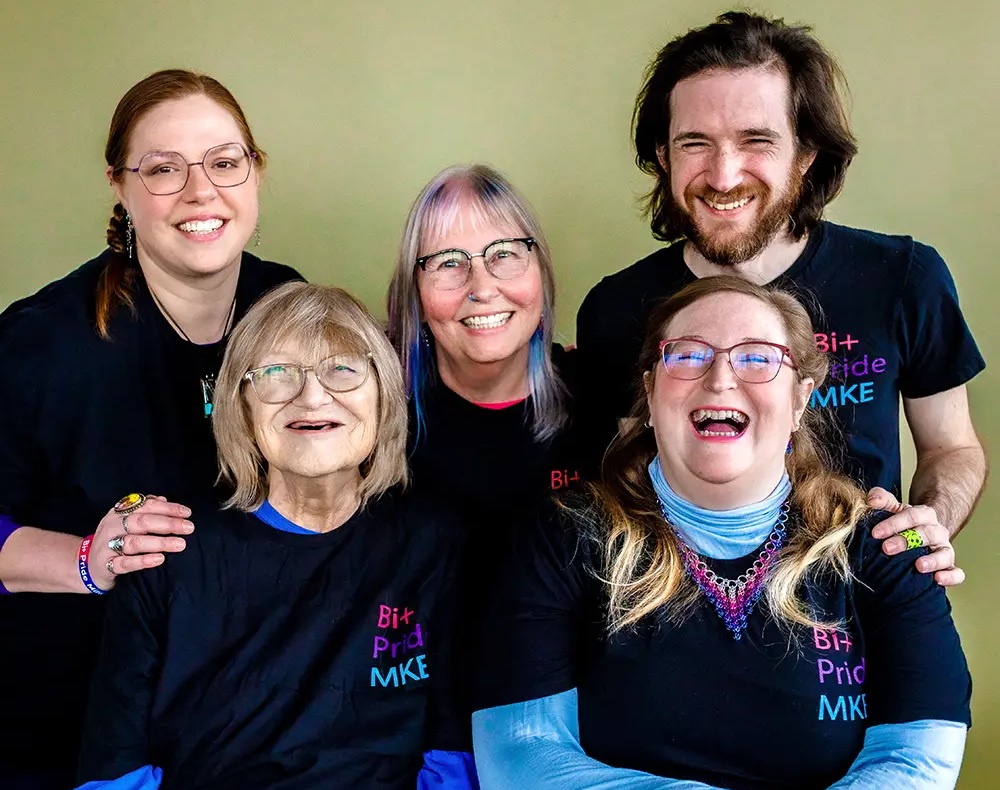 A group of five people smiling in Bi+ Pride Milwaukee shirts